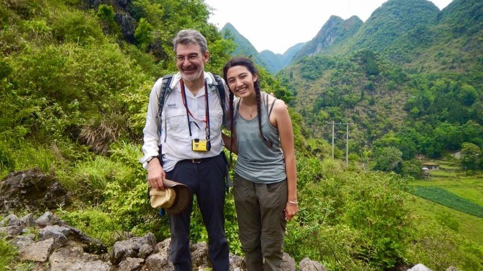 Geology professor stands with a student in valley while studying abroad in China