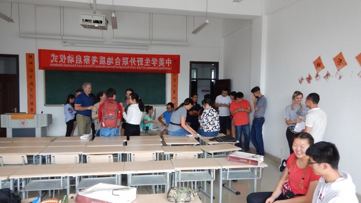 Trinity students gather with Chinese students in a classroom while studying in China